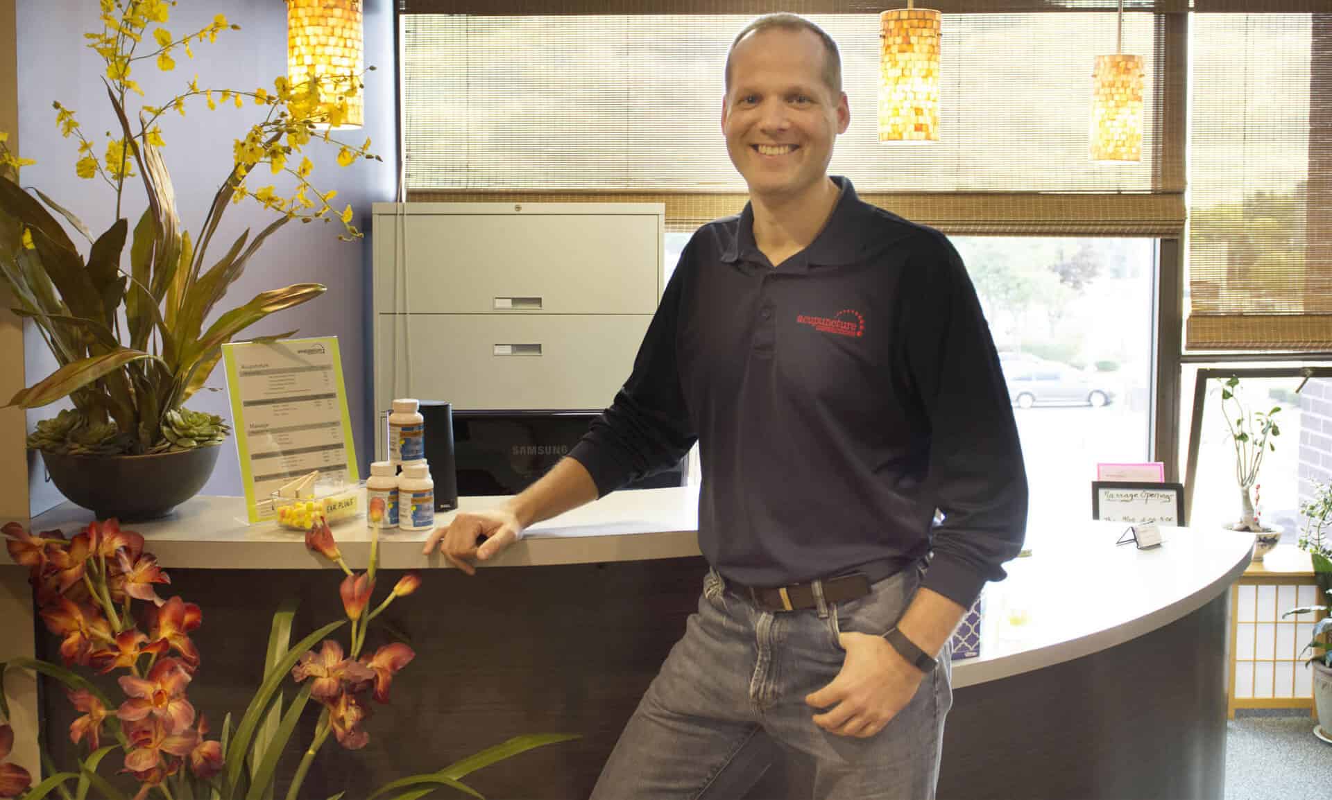 Robert Connors, lead practitioner at Acupuncture Connections, in the reception area of the Framingham clinic